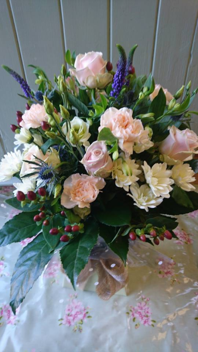 Thistle Berry - Lovely fresh flowers in hand tie arrangement presented in an aqua box. Nice mix of flowers in pale pinks and whites to include beery foliage.