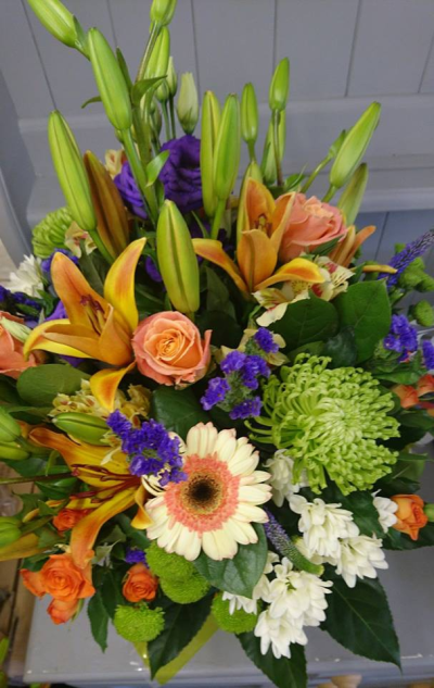 Mellow Mix - Beautiful flowers arranged into a hand tie, presented in an aqua box. Nice seasonal mix in pale orange, purple and whites to include lush foliage.